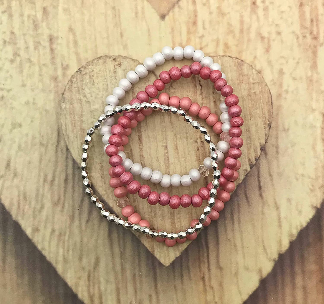 Set of 4 Pink, White, and Silver Stretch Bracelets on a Heart Shaped Wooden Block from Scott D Jewelry Designs