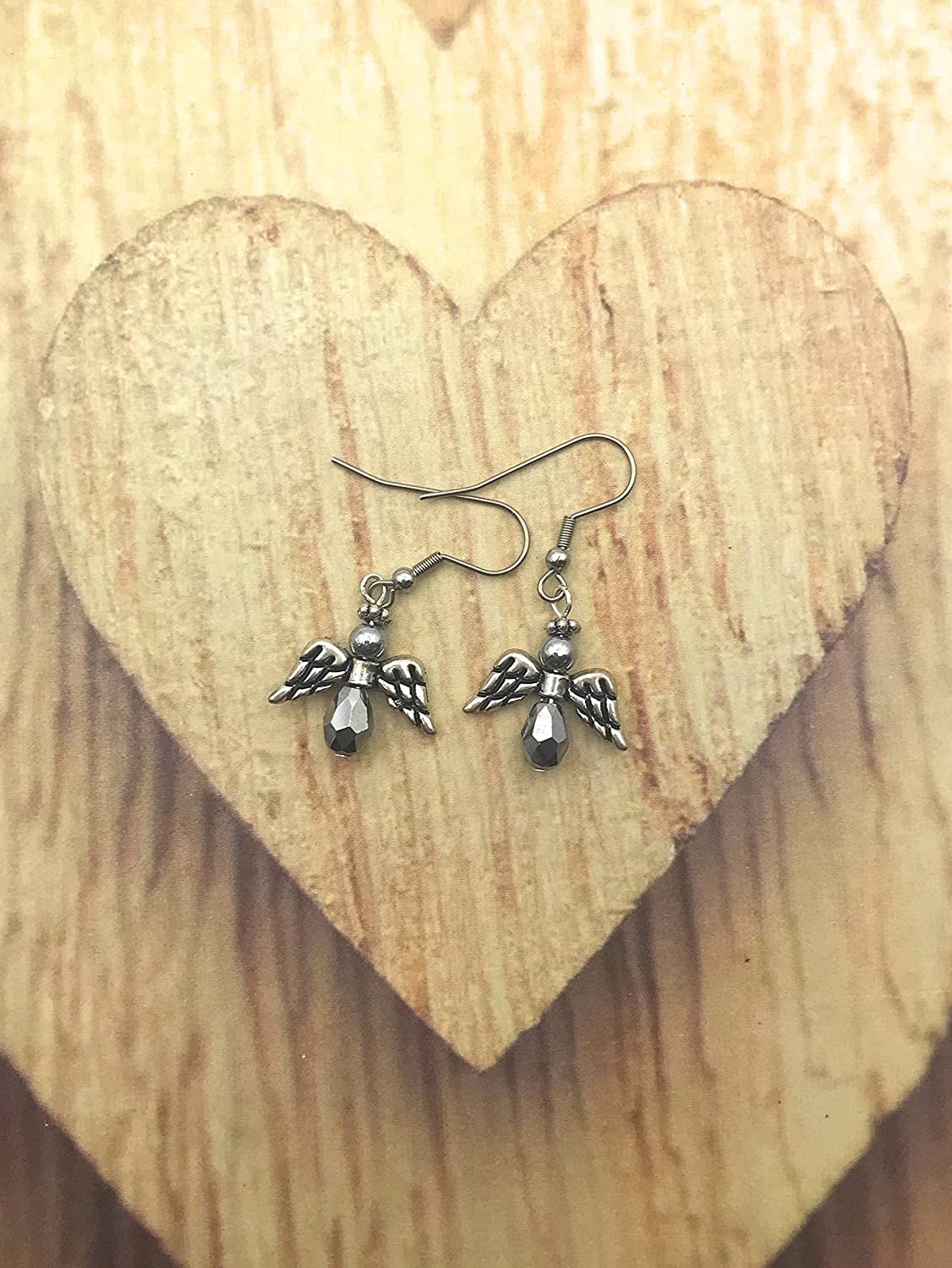 Silver Crystal Angel Dangle Earrings on Wooden heart Shaped Display from Scott D Jewelry Designs