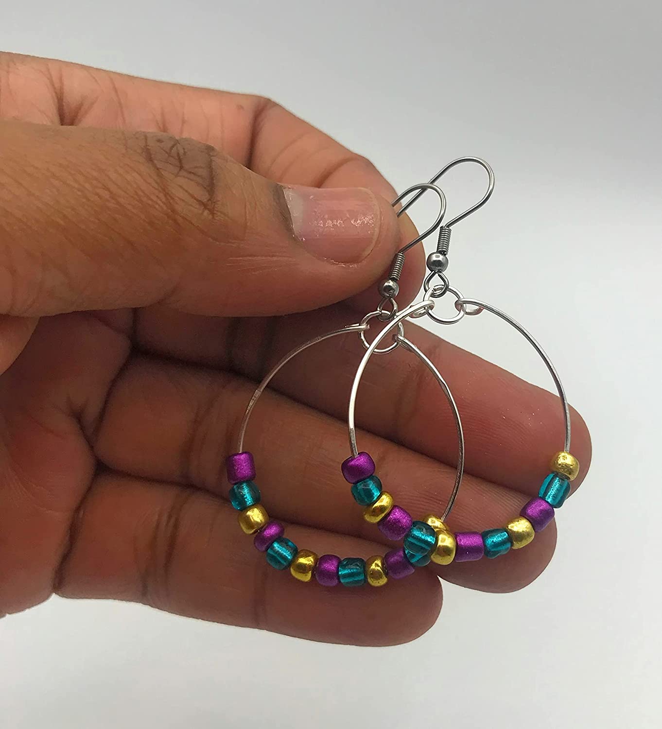 Mardi Gras Beaded Hoop Earrings held by the finger tips from Scott D Jewelry Designs