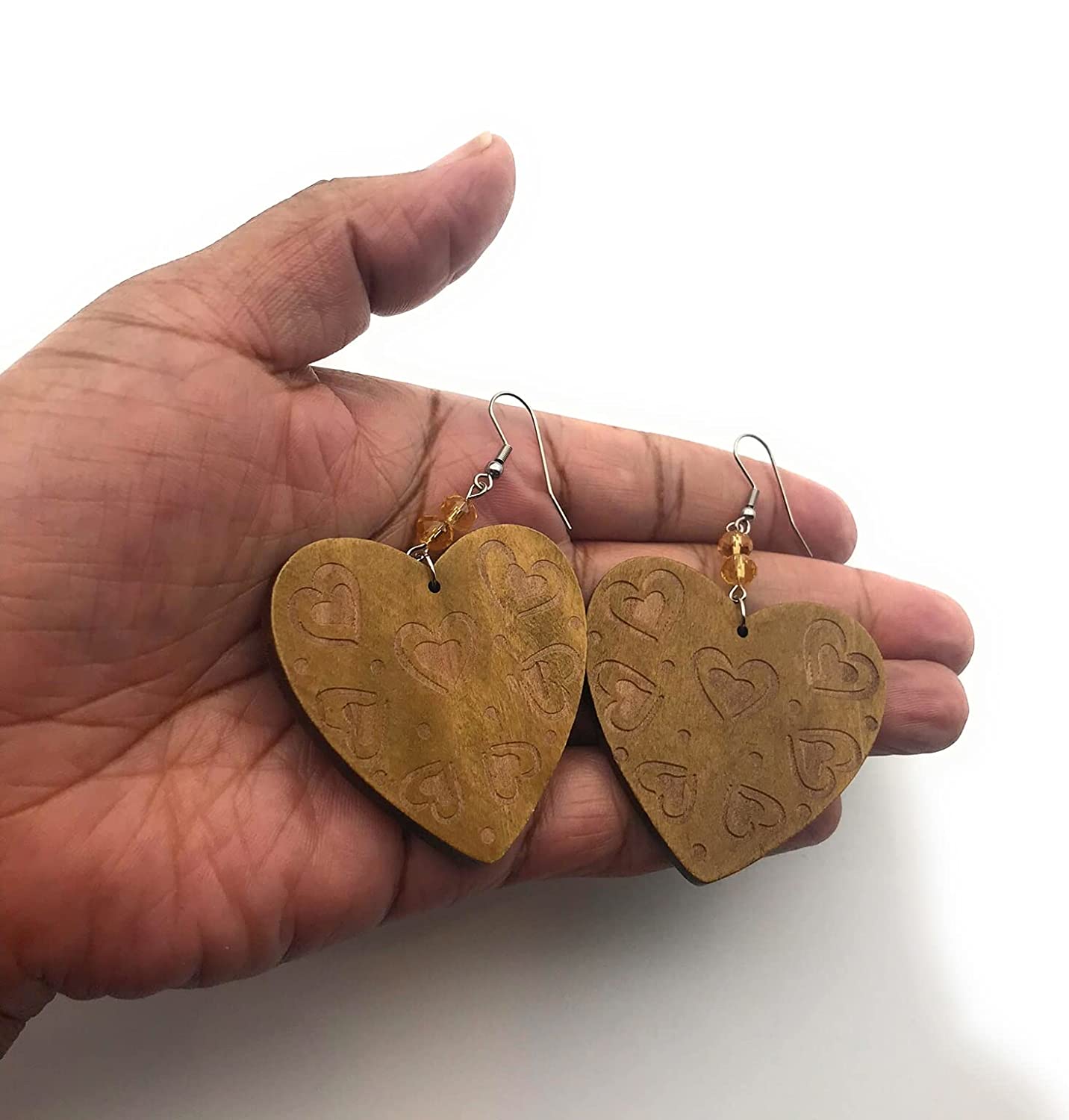 Wood Heart Swirl Pattern Earrings in Palm of Hand from Scott D Jewelry Designs