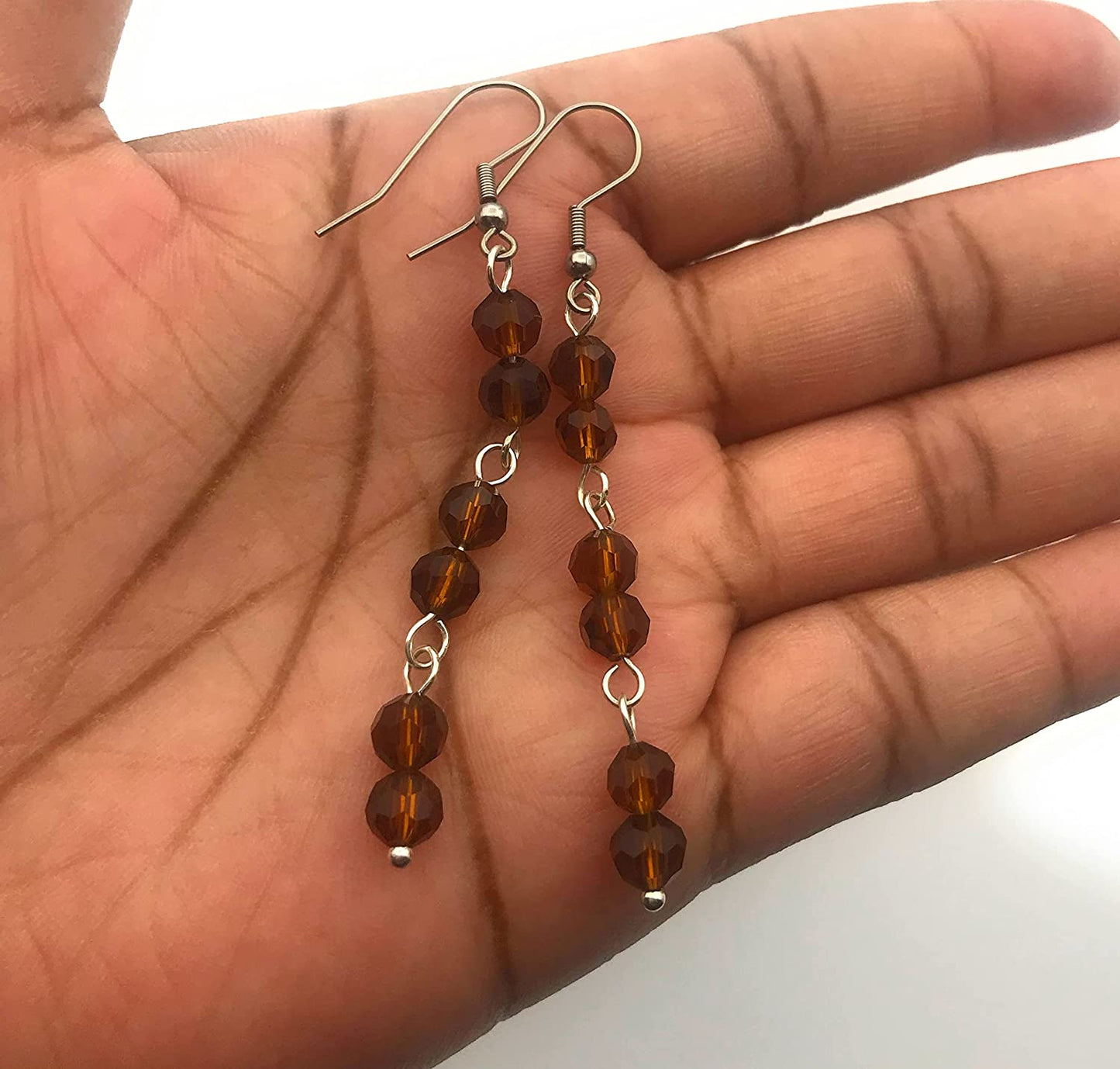 Brown Beaded Link Dangle Earrings Displayed in Hand by Scott D Jewelry Designs