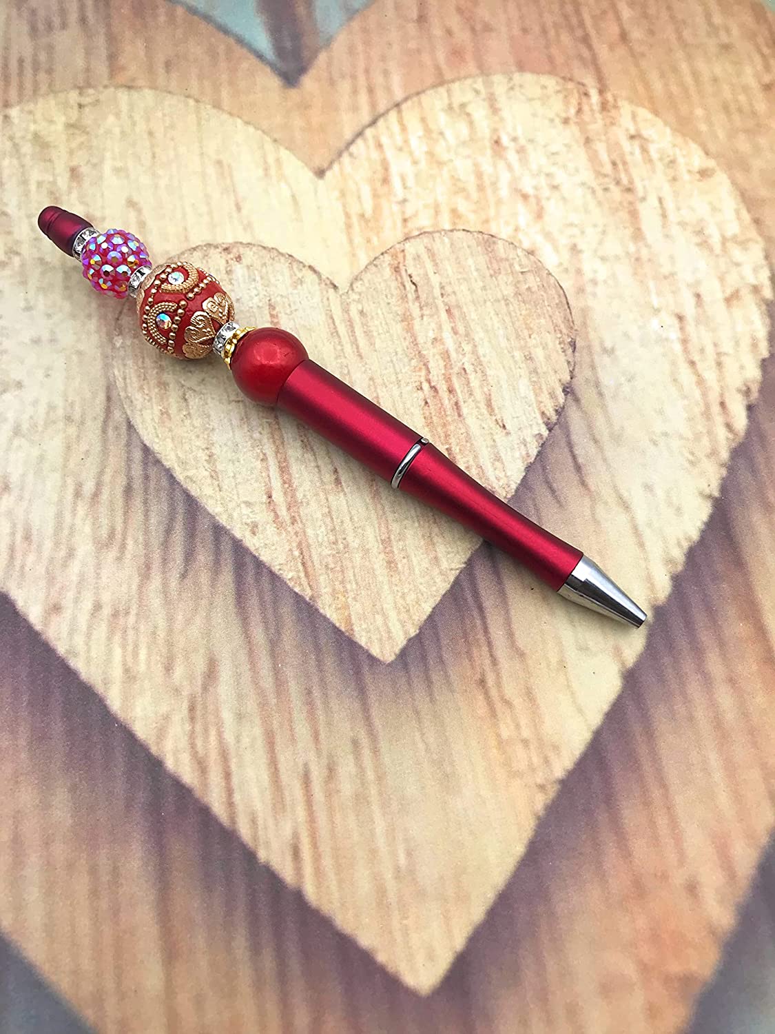 Red and Gold Beaded Ink Pen Diagonal View on Heart Shaped Wooden Display from Scott D Jewelry Designs