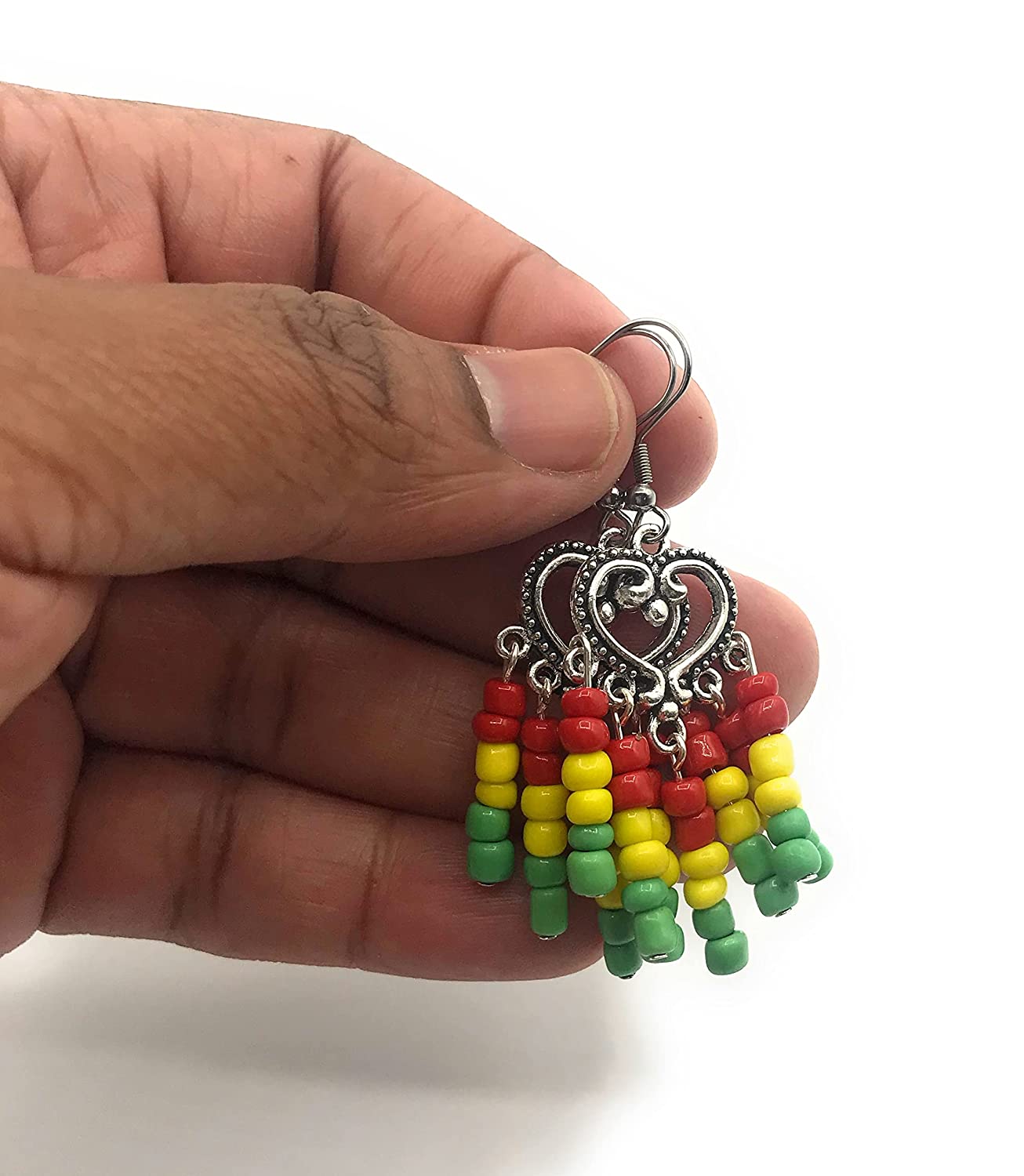 Rasta earrings in red yellow and green dangling by the fingertips from Scott D Jewelry Designs