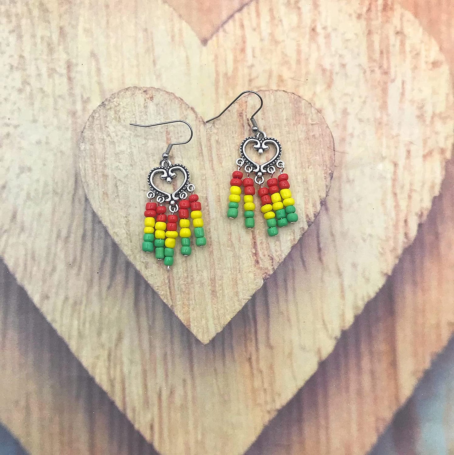 Rasta earrings in red yellow and green on a wooden display from Scott D Jewelry Designs
